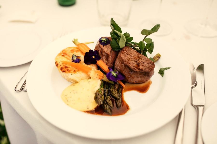 An elegantly plated beef fillet main course, ready for formal dining.