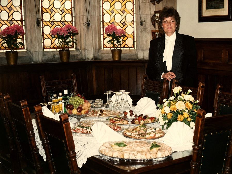 Sally standing beside an elegantly laid table set for canape and drinks service.