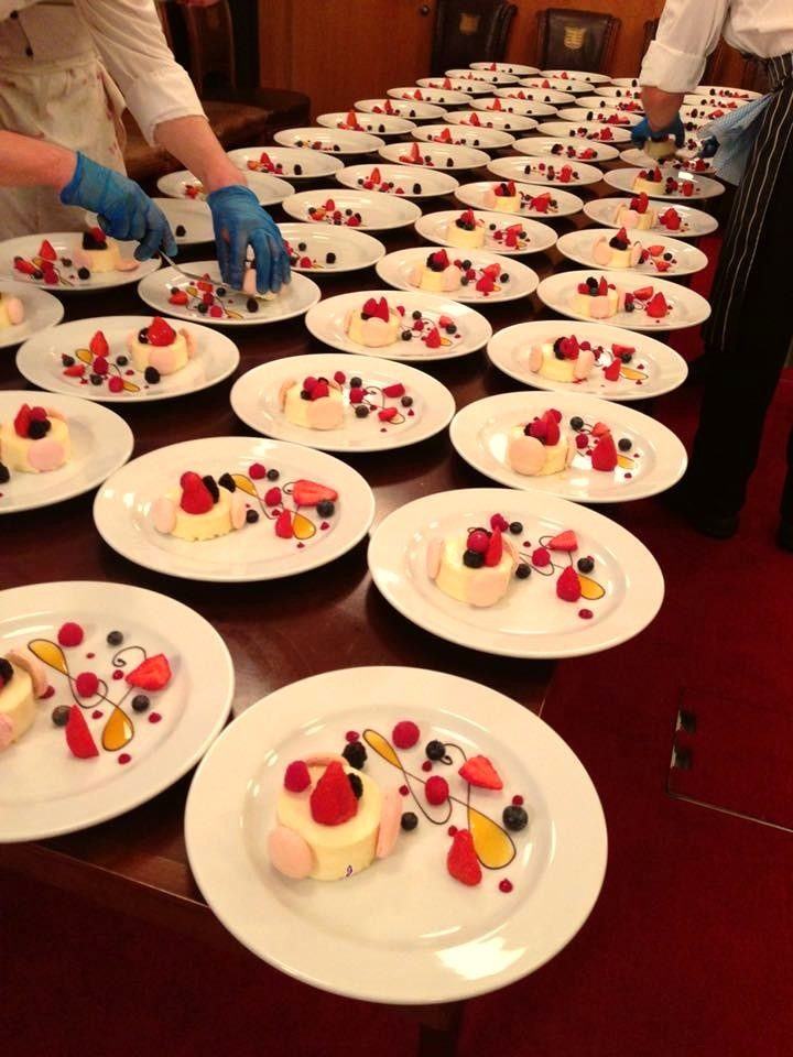 Rows of individually plated desserts ready for formal dining service.
